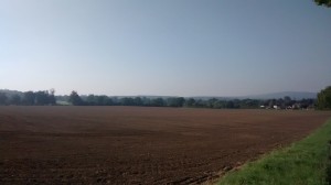 Distant view of Brockham over the recently ploughed fields, with Leith Hill in the distance. 